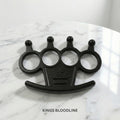 Black knuckle duster on a marble surface.