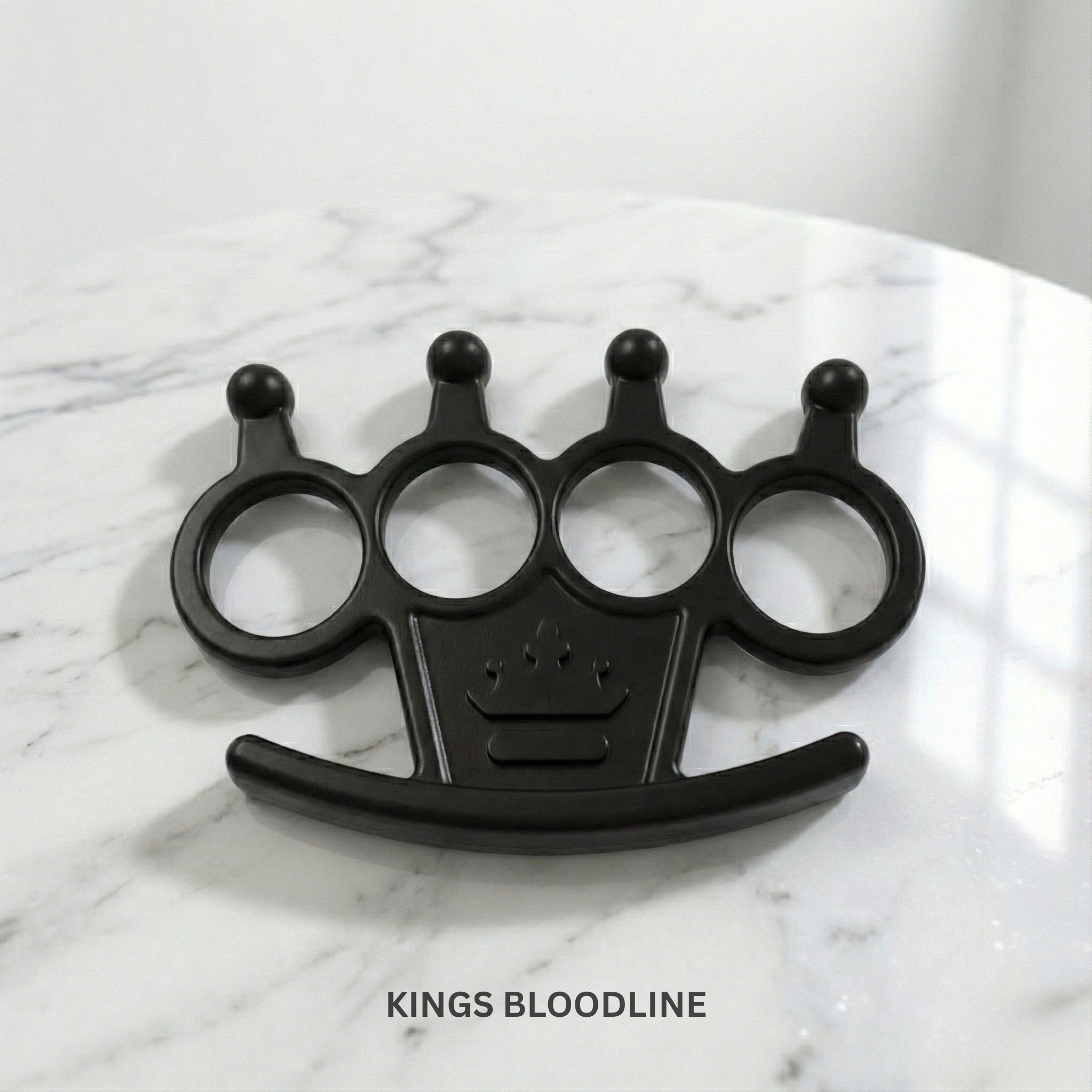 Black knuckle duster on a marble surface.