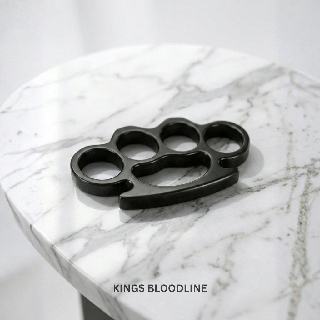 Black knuckle duster on a marble surface