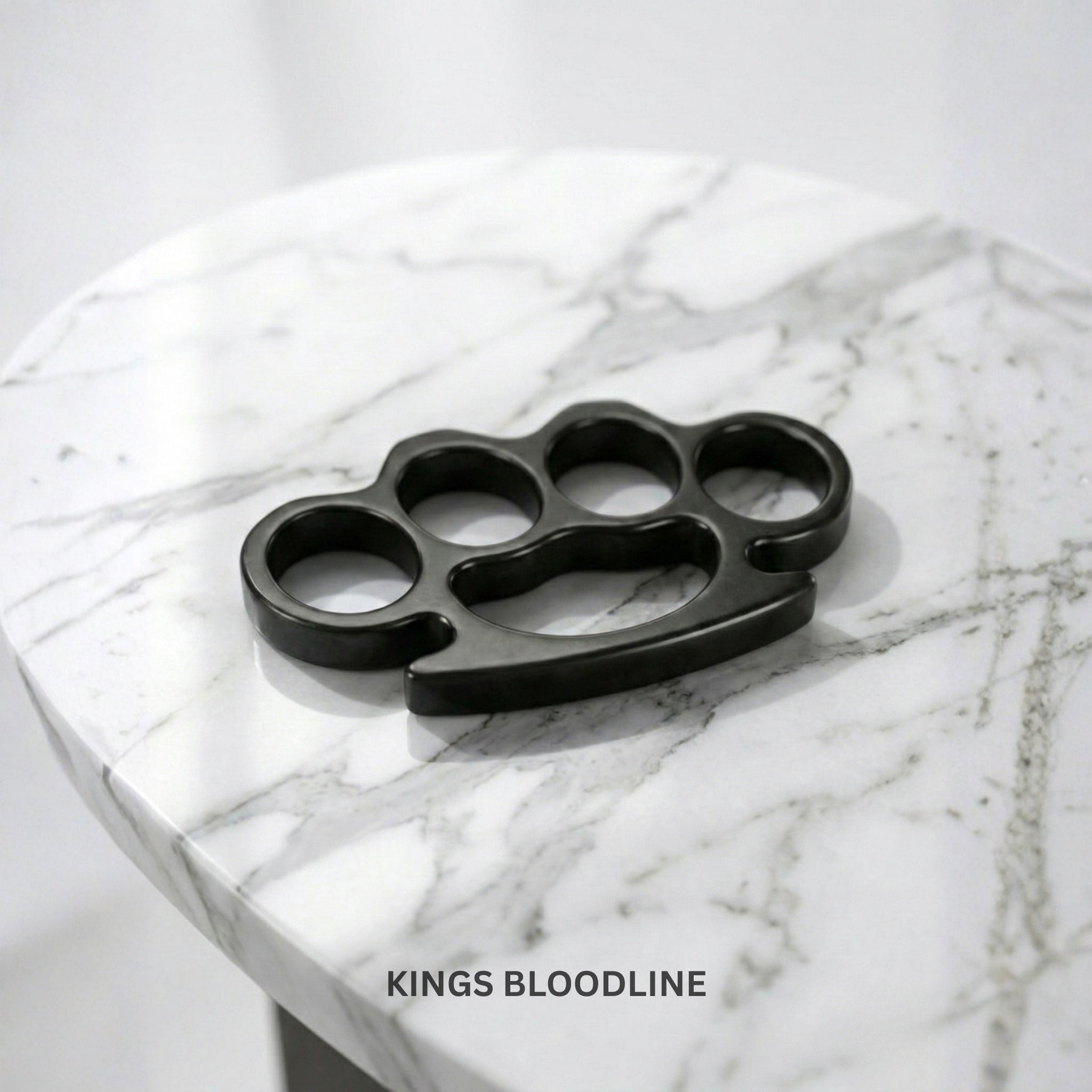 Black knuckle duster on a marble surface
