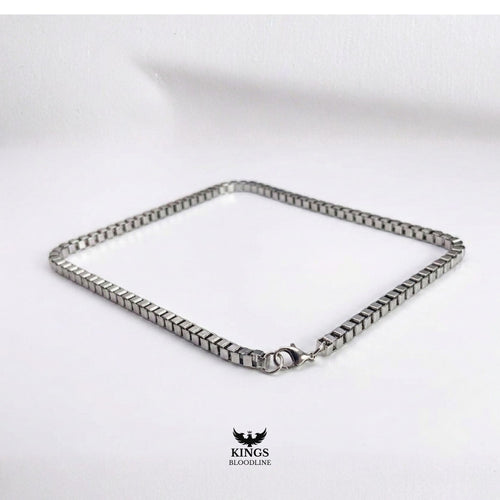 Silver Box chain on white table